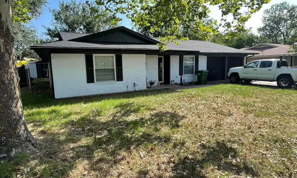 Professional roofing crew working on a residential roof in Forsyth